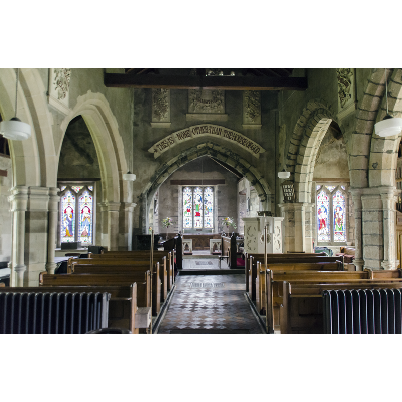 Source caption: "The church dates from the 11th century onwards, and was restored in 1871. There is a western tower, nave with north and south aisles and chancel. The tower has a battlemented parapet and pinnacles. The clock dates from 1871. There are several fragments of reused masonry in the tower walls including 12th century chevron moulding. The tower arch is 11th century. The nave has north and south aisles with two bays, the south aisle is Early English, the north being a 19th century copy. The nave and aisle walls have carved stone texts. The south doorway is 14th century, and is there are several windows in the south wall from this time. Most of the internal fittings are 19th century, as is the stained glass."