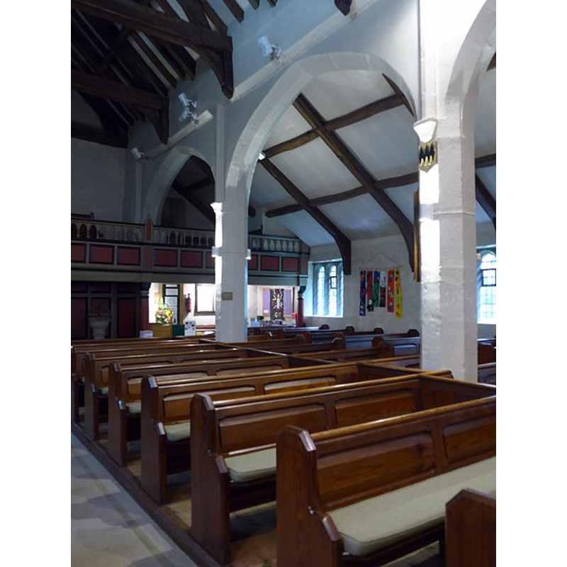 the modern (18thC) font is partially visible beneath the west gallery