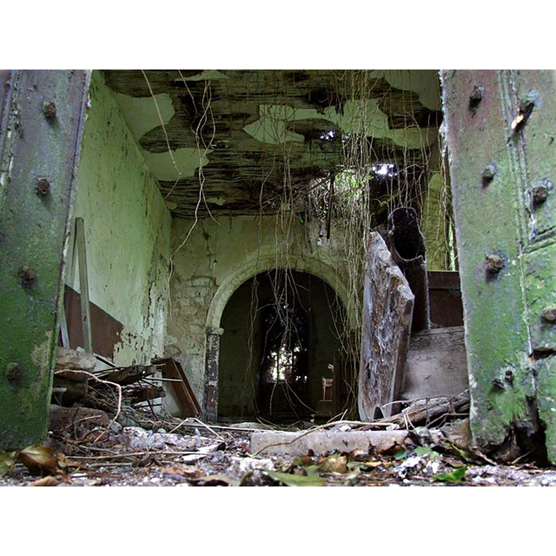 Source caption: "The former Church of St Peter, Low Toynton. This shot shows that most of the plaster laths have been revealed in the ceiling. The heavy covering of ivy is probably slowing the decay to the roof. The walls are certainly solid and it could stand for many more years. Wiki has it recorded as demolished and that is why I returned to the church six years after my previous visit. The shot also shows an upturned pew."