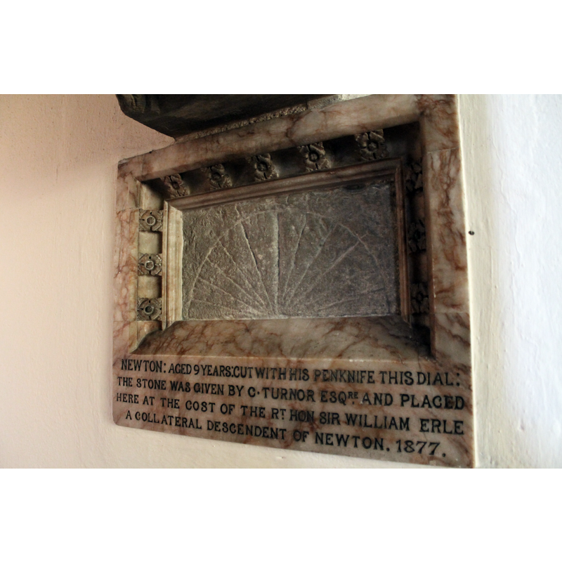 Source information: "Behind the organ is a sundial carved by the young Isaac Newton with his pen knife at the age of 9 at Woolsthorpe Manor. It was built into the wall at the time of the chapel's reconstruction"