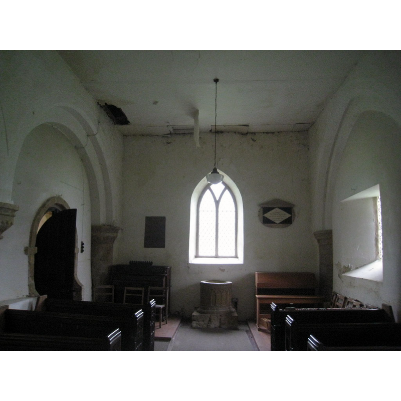 Source caption: "The interior looking west, All Saints, Croxby. Sadly neglected."