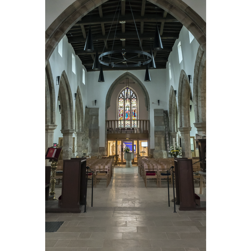 Source caption: "Looking west from the chancel. The new ringers gallery can be seen under the tower, with meeting room underneath."  -- the modern font is visble in the centre of the aisle, at the far back