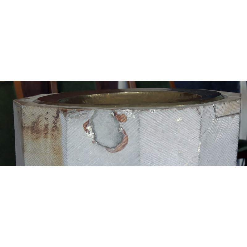 Notice the large new-stone repair on the right -- the hole on the left may have been caused by a flaw in the chemical composition of the stone.