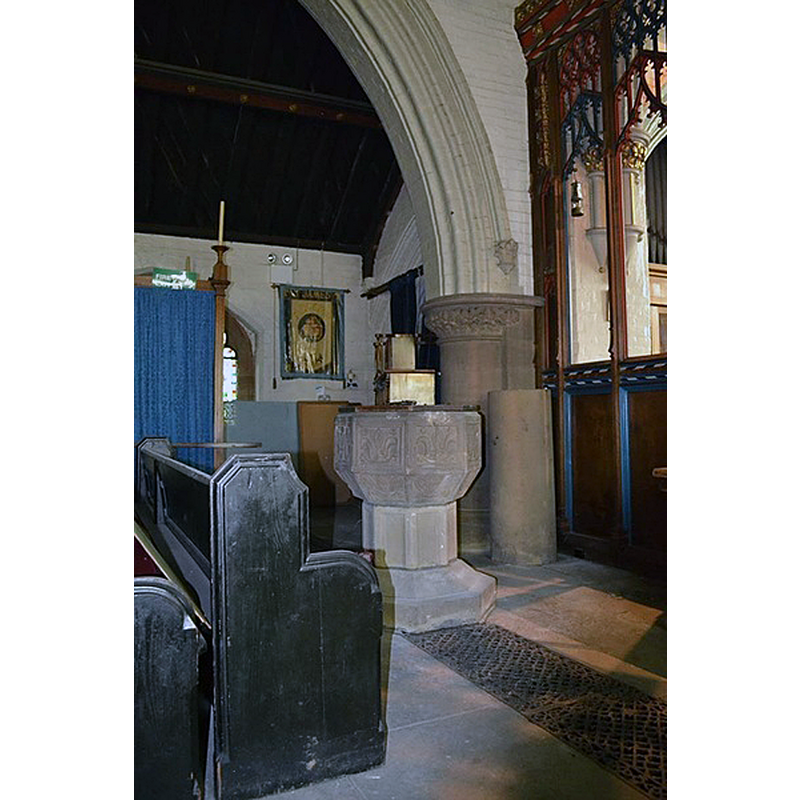 the modern baptismal font in its present location by the chancel screen [NB: at the time of the renovations undertaken in 2015-2016 "The west end has been dug up and the font has moved near its new place at the front."]
