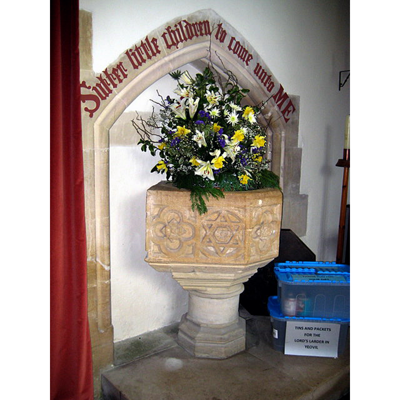 Source caption: "St Giles Church. The font is decorated with quatrefoils and six-cornered stars. The writing above the recess has been picked out in red since the last photograph was taken."