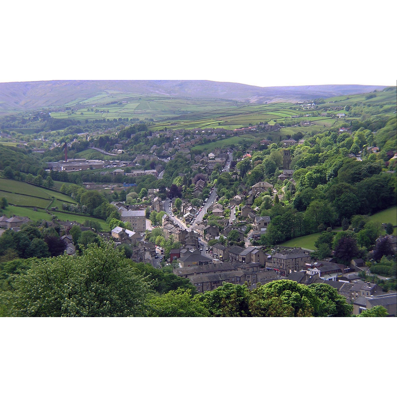 Source caption: "View of Holmfirth from Cliffs above Cliff Road, view is taken facing southwest. The A6024 (Woodhead Road) goes from the centre of the village to the top left of the photo" [the church is visible to the right of the A6024]