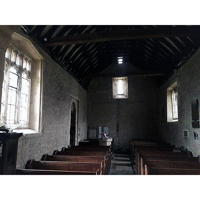 with a partial view of the font at the far end, opposite the south entranceway