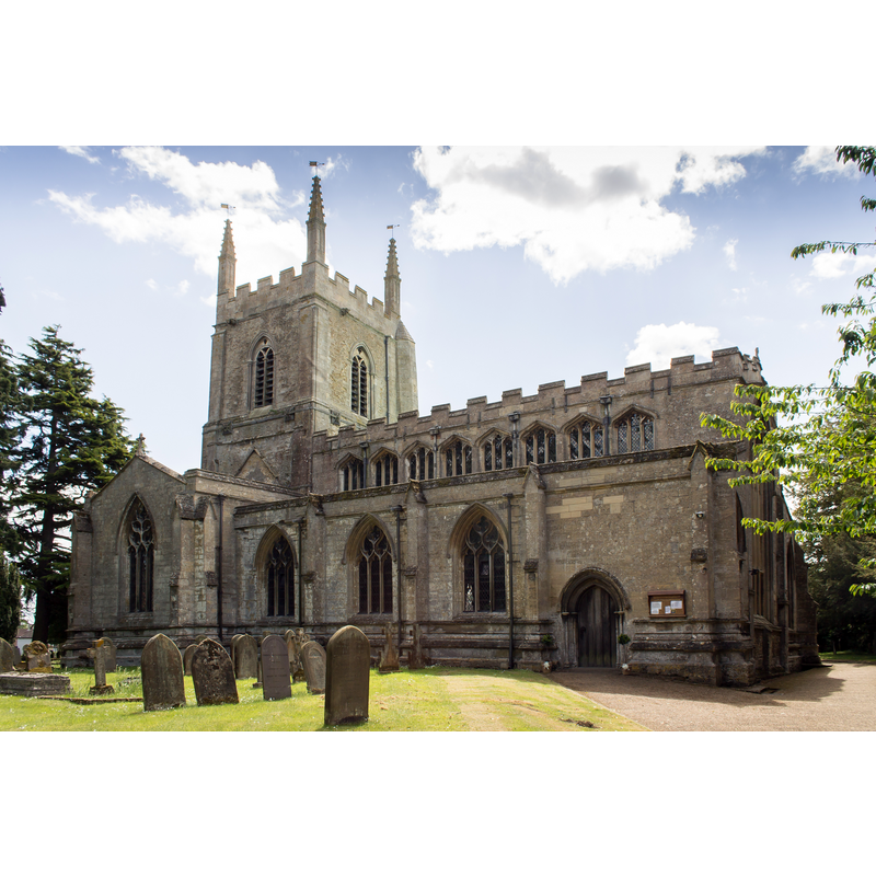 Source caption: "The church dates from the late 12th century onwards, although a church was mentioned in the Domesday book. Originally there was a cruciform Norman church, parts of which still remain. The church could have been an ex Anglo-Saxon Minster or new Collegiate foundation. There is a nave with north and south aisles, north and south transepts with crossing tower, chancel and south porch. The west front dates from circa 1170 and was remodelled in the 15th century. The nave was constructed in the first half of the 13th century, the north and south arcades are asymmetrical. There is a set of eight windows in the late 15th century clerestory. There are four-bay arcades, the north on hexagonal piers the south has one round and two quatrefoil piers. The chancel dates from the 12th century, and unusually has a sedilia with a single round arch. The crossing tower was remodelled around 1330, and the tower has battlements and pinnacles and several gargoyles. The arches of the crossing are leaning out of line, and an attempt was made in the 14th century to repair them. This can easily been seen when looking at the nave towards the chancel. The north transept has a 15th century tomb recess with the arms of Sir Thomas La Launde, died 1470. This may also be part of an Easter Sepulchre. The church has several monuments with brass plate designed by Pugin. The octagonal font is from the 15th century and has instruments of the passion on each face. There is a two manual organ by Binns, which was removed from Bailgate Methodist Church, Lincoln."