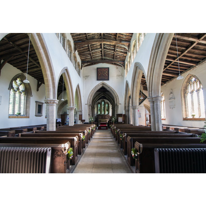 Source caption: "There is a nave with north and south aisles, north and south transepts with crossing tower, chancel and south porch. The west front dates from circa 1170 and was remodelled in the 15th century. The nave was constructed in the first half of the 13th century, the north and south arcades are asymmetrical. There is a set of eight windows in the late 15th century clerestory. There are four-bay arcades, the north on hexagonal piers the south has one round and two quatrefoil piers. The chancel dates from the 12th century, and unusually has a sedilia with a single round arch. The crossing tower was remodelled around 1330, and the tower has battlements and pinnacles and several gargoyles. The arches of the crossing are leaning out of line, and an attempt was made in the 14th century to repair them. This can easily been seen when looking at the nave towards the chancel. The north transept has a 15th century tomb recess with the arms of Sir Thomas La Launde, died 1470. This may also be part of an Easter Sepulchre. "