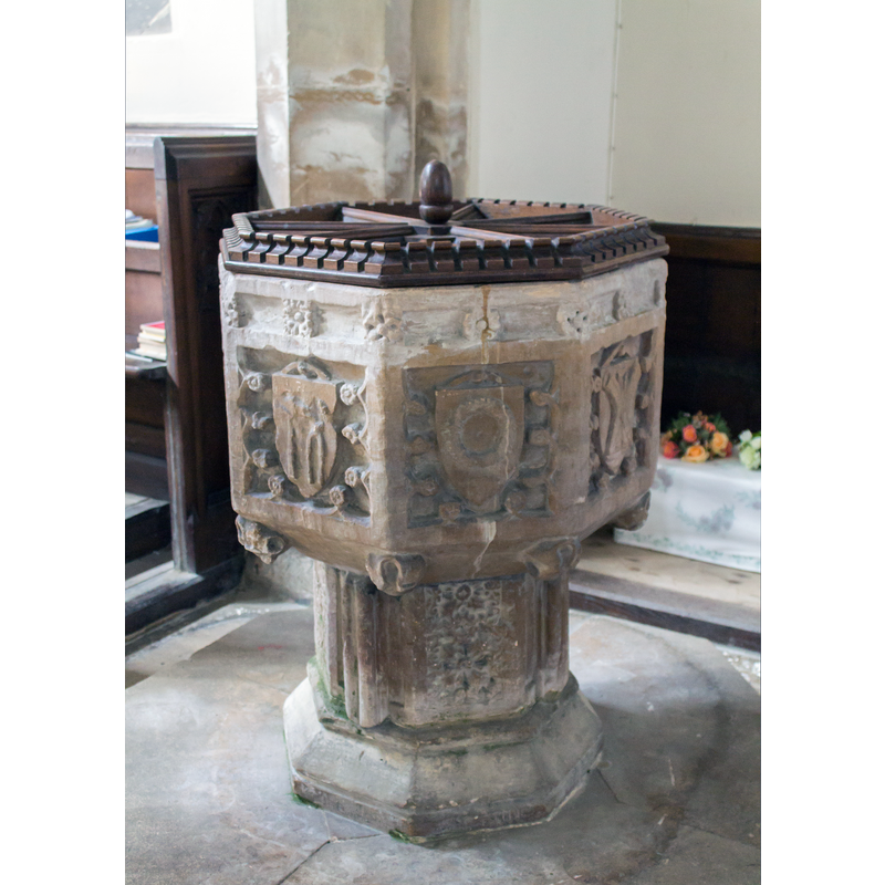 Source caption: "Font, St Andrew's church, Horbling. Carved with shields showing instruments of the passion."