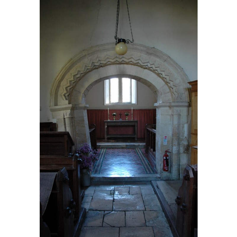 Source caption: "The interior of the small Stanley Pontlarge church, the Norman style arch connecting the nave and chancel lean considerably on one side. The chancel was rebuilt in 1860, this arch appears to have been restored at the same time."
