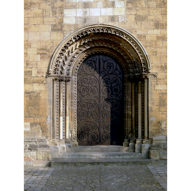 Source caption: "This is the fine Norman west doorway leading into the nave of the church."