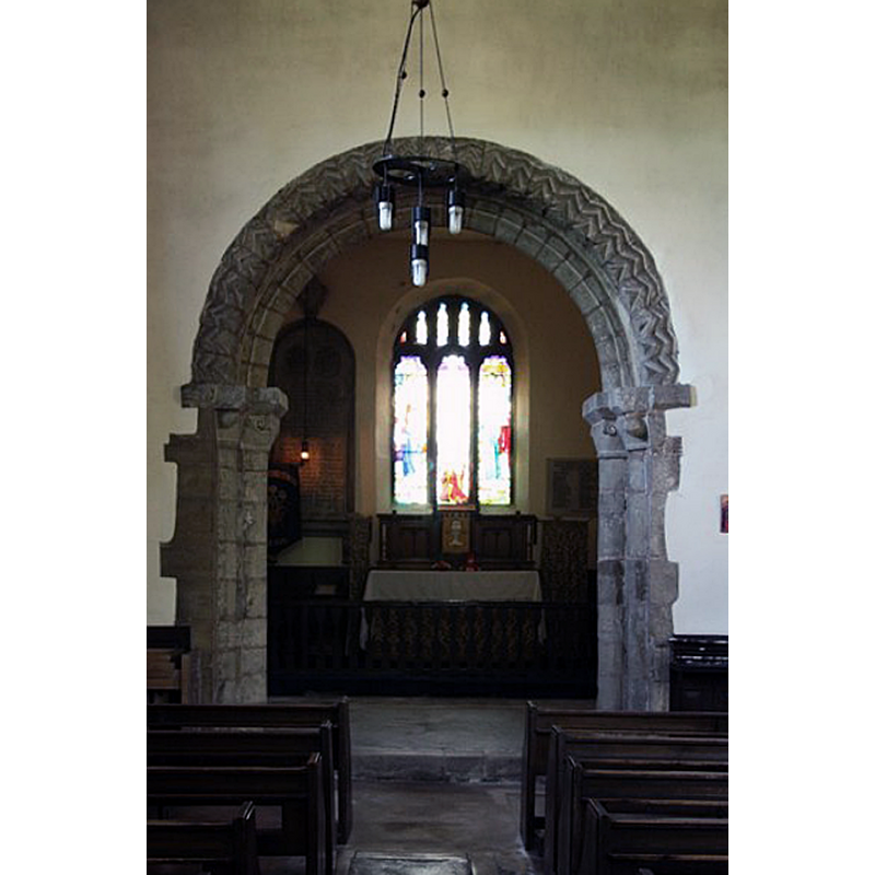 Source caption: "Former Norman chancel arch in St.John the Baptist's church, now linking the north aisle to the Lady Chapel".