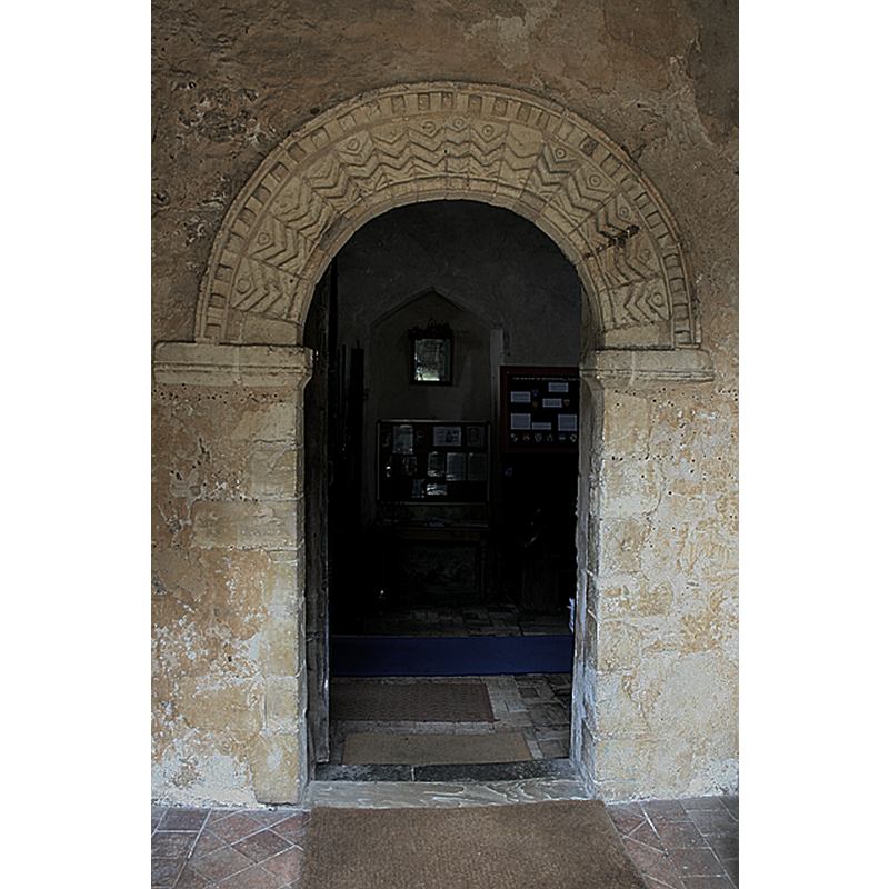 Source caption: "South door of St Edmund's Church, Bromeswell, featuring Norman chevron arch."