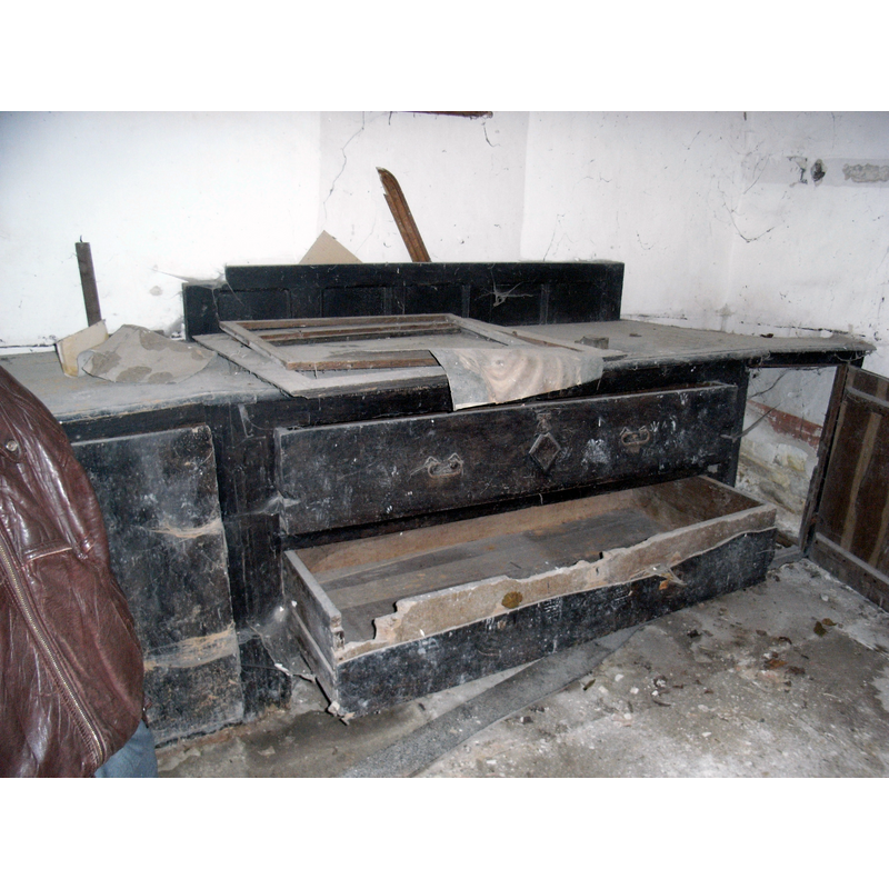 the furnishings of the disused church; here the cabinets of the sacristy in their decrepitude