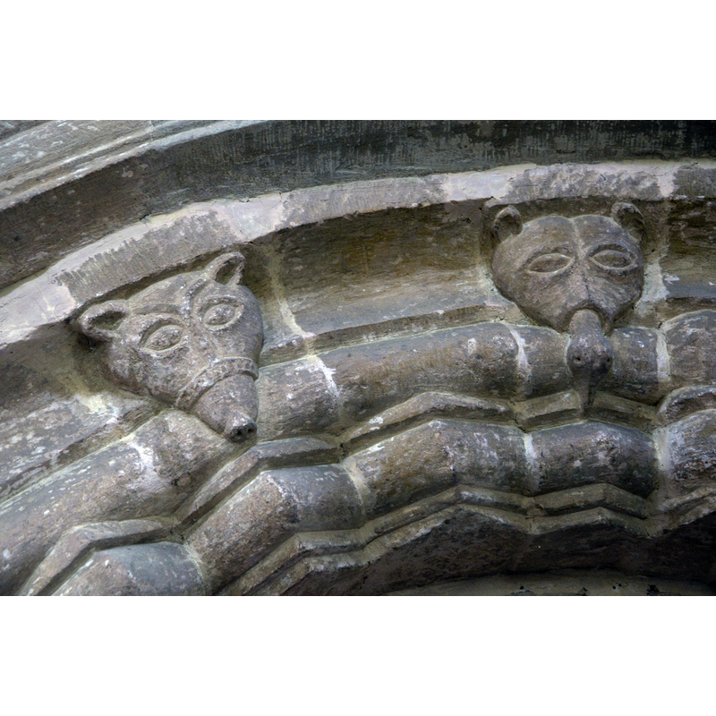 detail of the easternmost arch of the north arcade of the nave -- Source caption: "Detail of carvings on a Norman arch in St Mary's church."