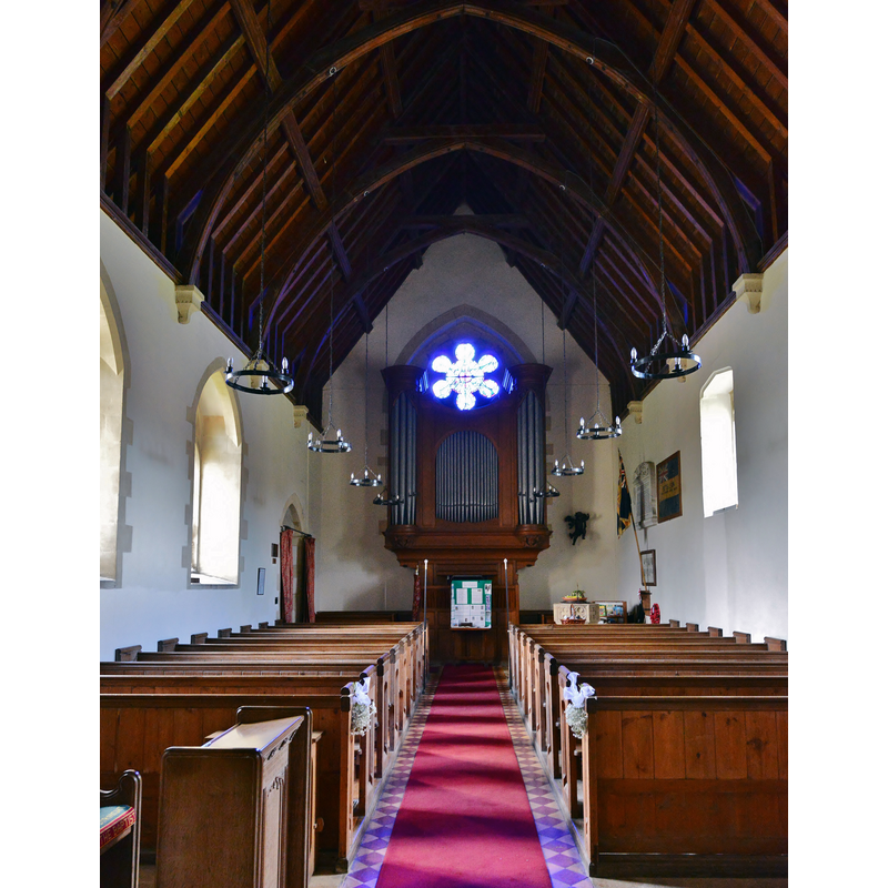 the top of the font is visible on the right [north] opposite the south entranceway