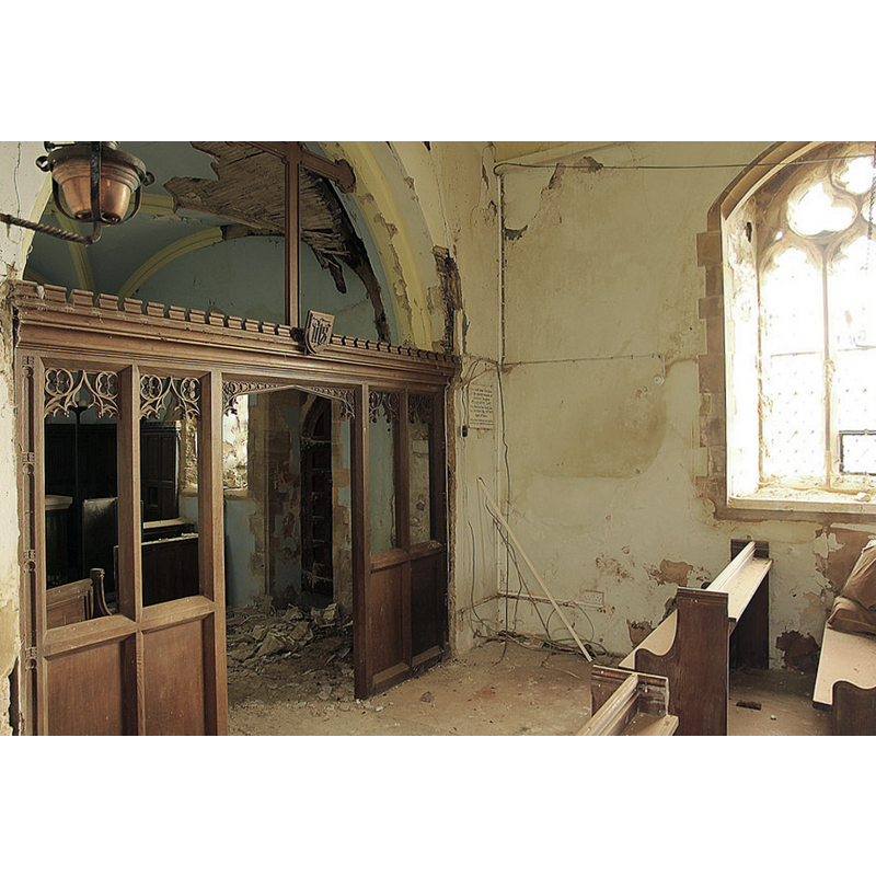 Source caption: "St.Michael's nave. Chancel screen and glimpse in to the chancel inside St.Michael's church with part of the 19th century quadripartite chancel vaulting collapsed in a pile of debris on the floor."