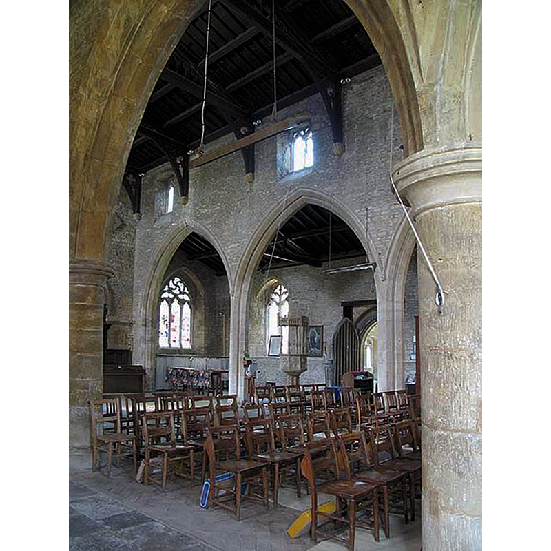 the font in the south aisle, by the south entranceway, seen across the nave from the north aisle