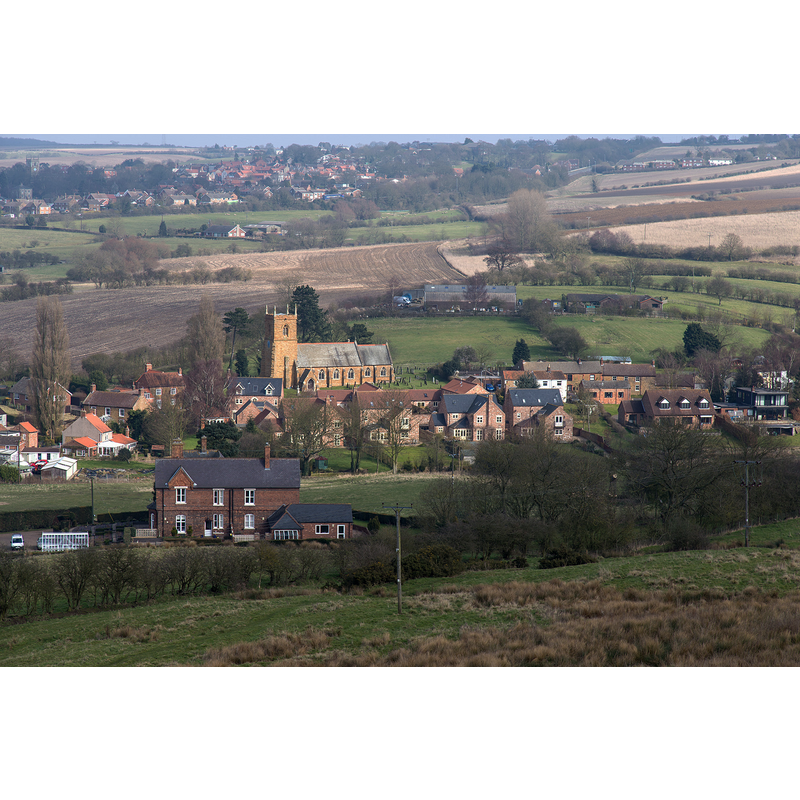 Source caption: "Nettleton from Nettleton Hill. Looking north east from the permissive path over Nettleton Hill towards the village of Nettleton. Prominent in the centre of the photo is the church of St. John the Baptist, some half a kilometre away."