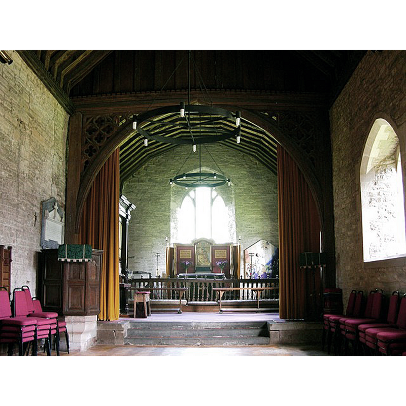 Source caption: "Interior, St Michael, Winforton. Now a combined church and village hall - the liturgical stuff jammed in at the East end. The wooden chancel arch doesn't look Victorian - Pevsner and John Leonard don't comment on it however."  -- the font is now located in the chancel, left [north] side, partly visible here beyong the communion railing.