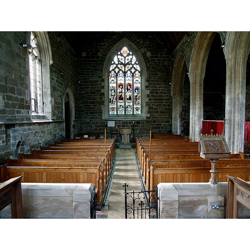 Source caption: "Interior of the Church of St Peter & St Paul, Old Bolingbroke. This view is looking towards the stained glass west window by Kempe & Tower. The two central figures are, as you might expect, St Peter and Saint Paul". -- the font is located at the far back, beneath the window