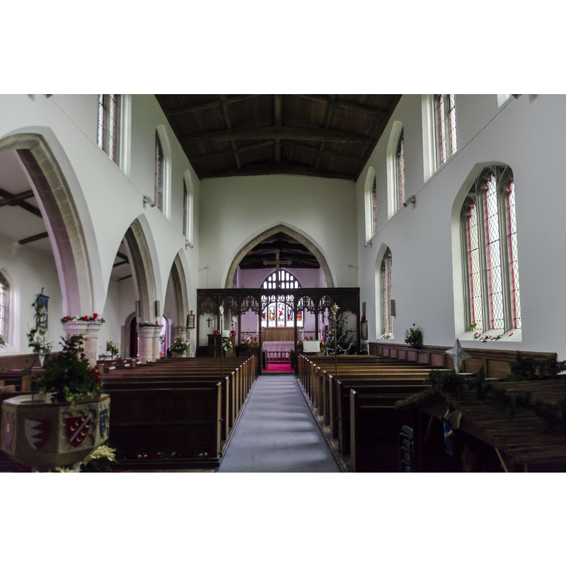 Source caption: "12th Century onwards. A clerestoried nave, chancel, north aisle and chapel with western tower, which was rebuilt in 1908. The north arcade is 13th C. of 3 bays, also 13th C. tower arch. The font is a 15th C. octagonal bowl carved with coats of arms. The oldest part of the church is the wall of the north aisle with the doorway in it believed to be Saxon but is more probably Early Norman dating back to AD 1100, the rest of the building appears to be Perpendicular in style dating from AD 1350 to AD 1500. The nave roof is 15th century."