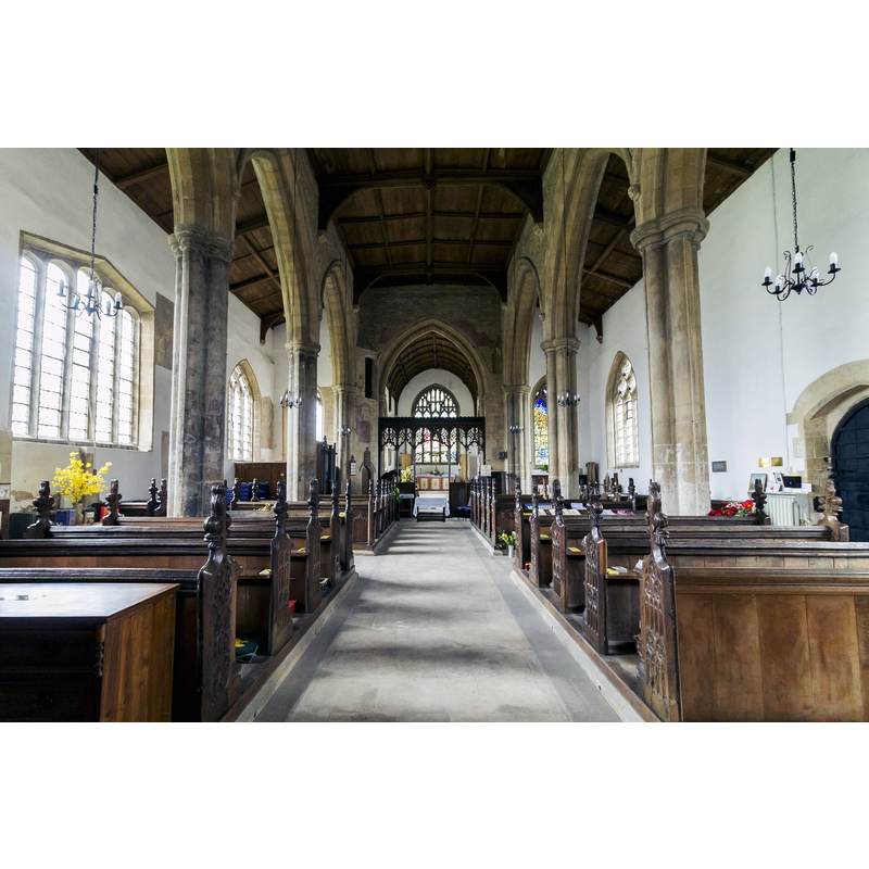 Source caption: "The present church as it was erected in the first half of the 14th century. The chancel is built in the Perpendicular style the remainder belonging to the Late Decorated style period of 1315 to 1360. There are signs of an earlier structure as in the north wall of the nave where there was once a doorway, on either side of which are displaced capitals of an earlier doorway in Norman style. In the south aisle is a double aumbrey and piscina. The presence of these items indicates that there would have been a chapel here at some point. The Rood screen is of the Decorated period. The screen is in light oak and bears carvings of an eagle, lion, dragons, a monkey fighting with a dog, a cat catching a mouse, and a fox with a bird in its mouth. The chancel was rebuilt in 1878. There is a vaulted triple sedilia just before the east wall and another piscina. The organ was supplied by Messrs, Cousans of Lincoln in 1923 at a cost of £253 being dedicated at morning service on 23rd December 1923. Formerly hand-pumped, an electrical blower was installed in 1949. Cousans thoroughly overhauled the organ in Summer 2007 at a cost of just under £4,000. The roof and floor of the nave were renewed during major reconstruction work in 1907-8, and fragments of an old wall painting were revealed on the north wall of the north aisle."