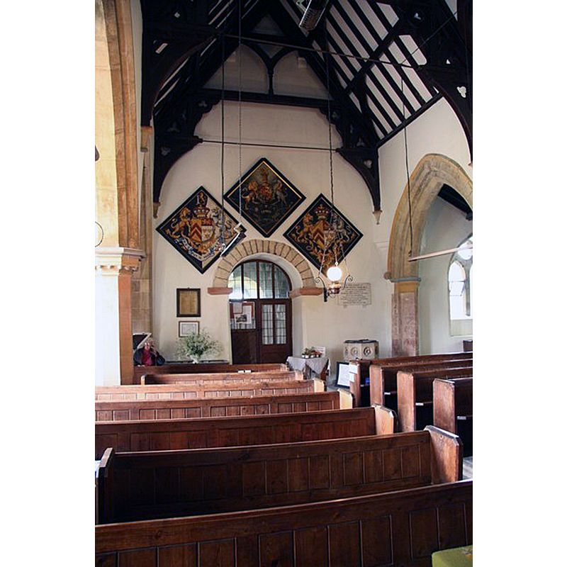 the modern font is partially visible at the far end, to the right of the 12thC tower arch