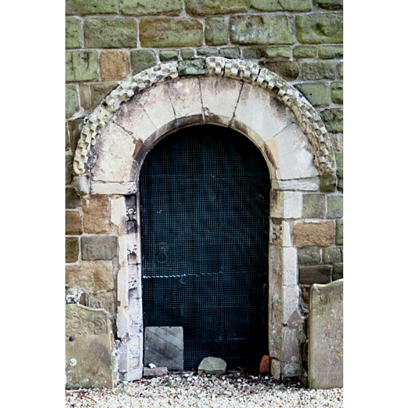 Source caption: "Norman Doorway. At the west end of the south aisle, the only bit of Norman in an otherwise entirely Gothic church, single-chamfered with billet in the hood mould. Said to have come from the nearby ruined church of St.Andrew at Calceby".