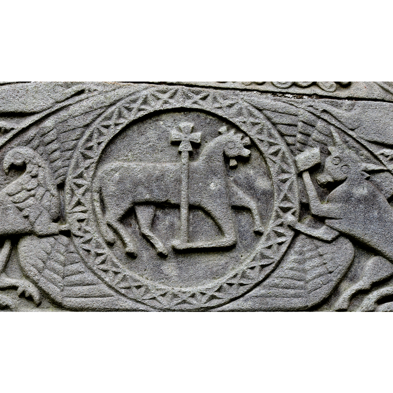 like the Agnus Dei on the baptismal font at Stottendon, its body appears more bovine than ovine; unlike the Stottendon Agnus Dei, however, the head here is nimbed