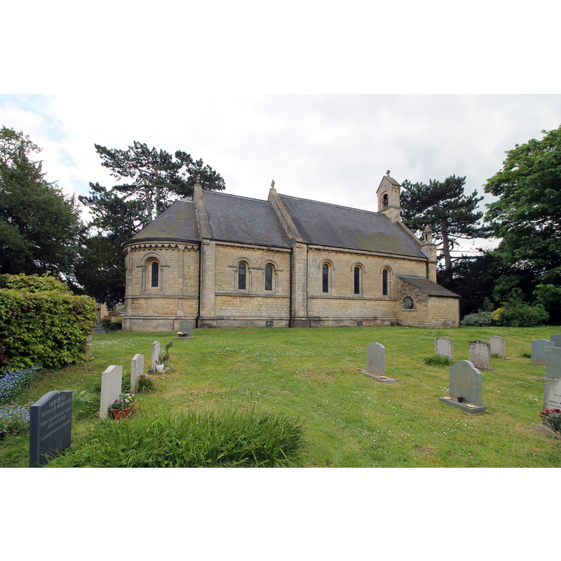 Source caption: "There is evidence from 1271 that there was a church before the current one. The previous one was built in red brick, fell into disrepair and was demolished. The church was built in 1860 by John Dobson. There is a nave with western bellcote with one bell, chancel with apsoidal sanctuary, south porch, and north vestry. The whole church is built in the Norman revival style. Externally, the apse has a corbel table of carved heads, and there are chevron and dogtooth decorations around the windows. Inside there is a ribbed vault to the apse."
