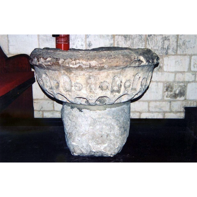 Source caption: "This Saxon font in St Clement’s, Worlaby, was discarded in the early twentieth century and used as a garden tub for sixty years."  Pevsner, Harris and Antram (1989) are more reluctant to commit: "Font. disused, under the tower, circular. How can these strange depressions and blobs be dated?"  Certainly not Saxon.