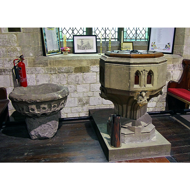 Source caption: "The C19th stone font is in the south aisle. Next to it on the floor is the remains of the Saxon font, having been serving as a garden tub for many years."