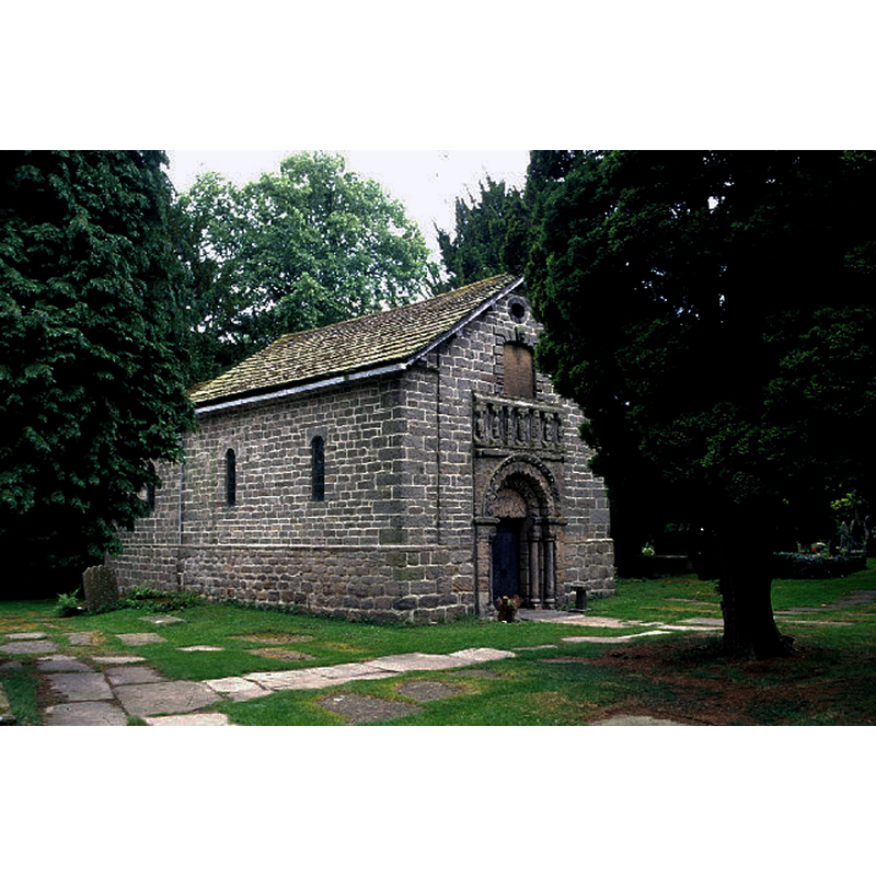 Listed in Historic England [Listing NGR: SJ9008676902]: "Chapel: c.1150 but rebuilt and restored 1747 [...] Tympanum has figure of Christ in Majesty (now badly worn) above a pair of studded oak doors. Above the corbel table are 7 now defaced figures, said to represent the Trinity, St.Peter, Richard I and figures of church and state."