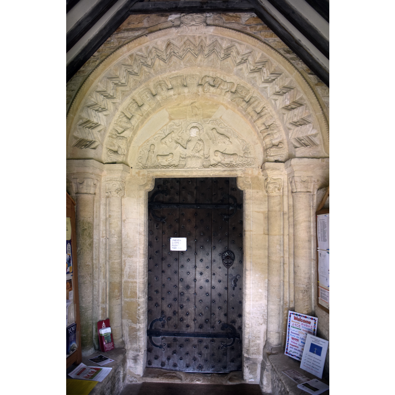 Source caption: "Pictured is the Norman (1160) south doorway, once open but enclosed by the 13yh Century porch."