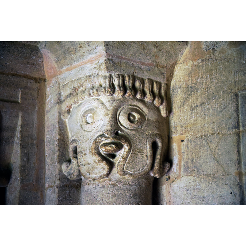 Source caption: "Pictured is one of the Norman (1160) beakheads of the south doorway capitals. The two are said to have represented the founder, Richard of Cormeilles, and his wife. I think this one is the former."
