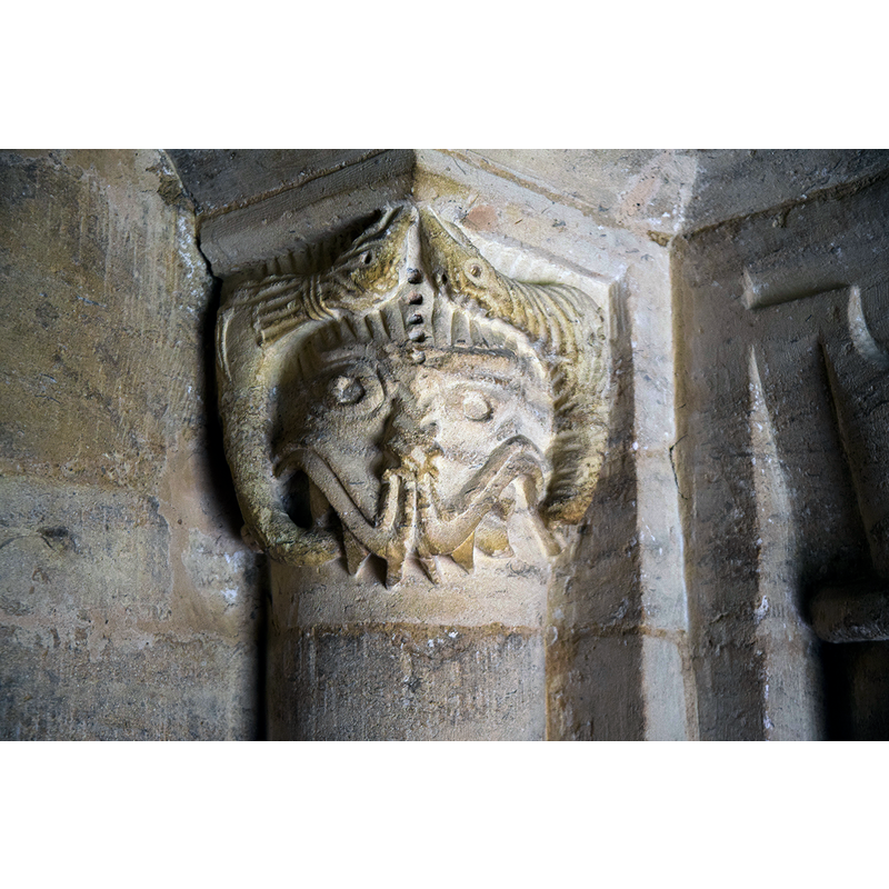 Source caption: "Pictured is one of the Norman (1160) beakheads of the south doorway capitals. The two are said to have represented the founder, Richard of Cormeilles, and his wife. I think this one is the wife! "