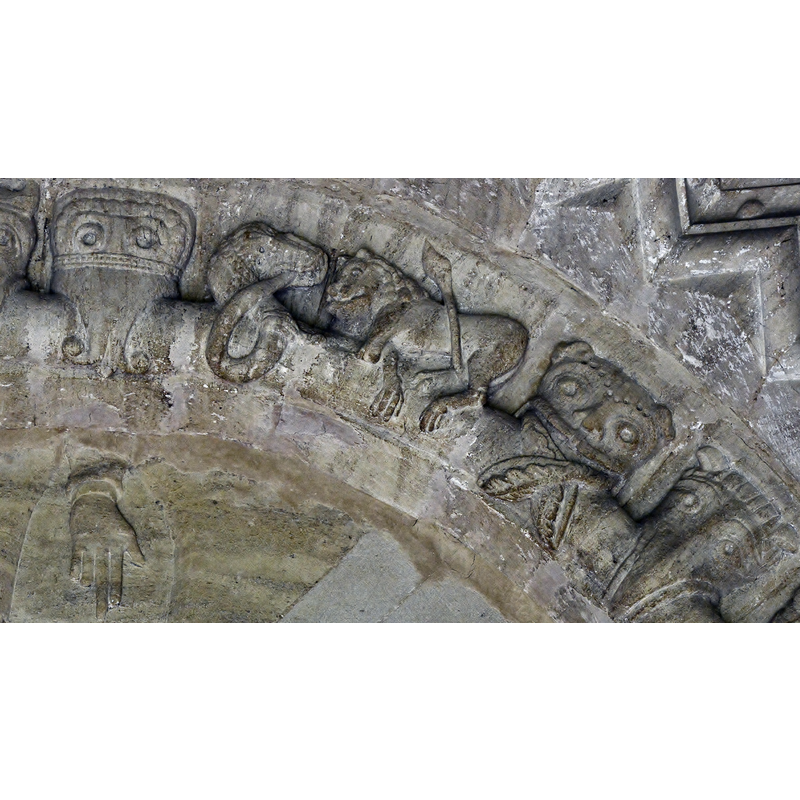 Source caption: "Elkstone, the church of St. John the Evangelist: Norman tympanum in the south porch. A selection of beakheads above the tympanum. A snake looks at a lion while it eats its own tail."