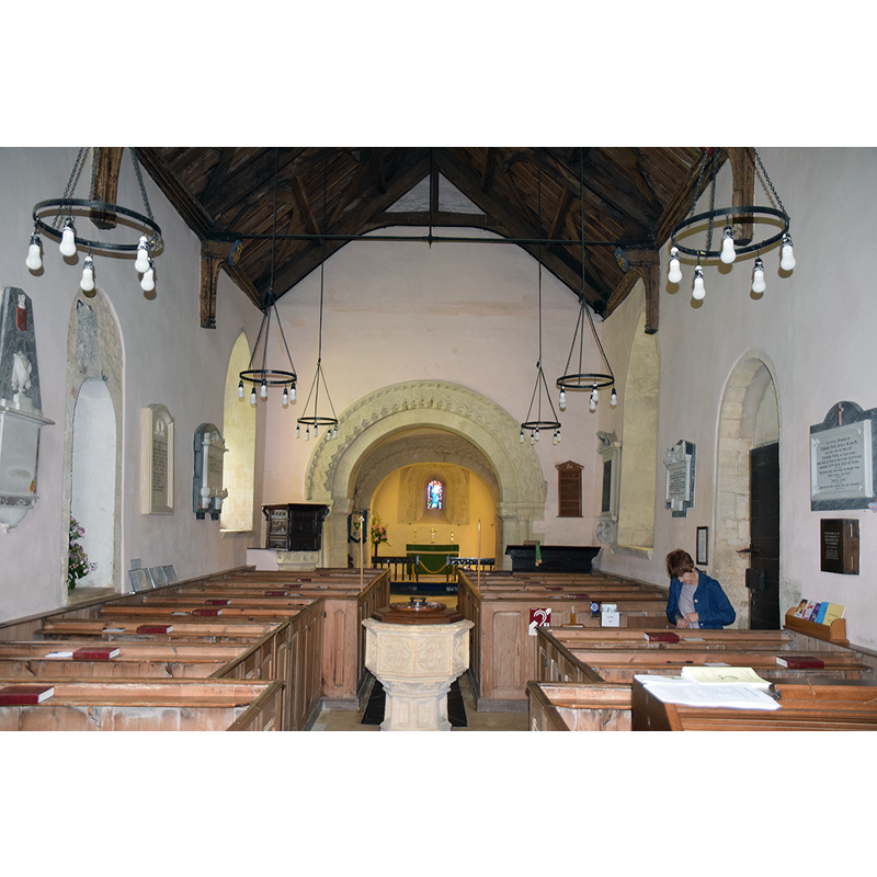 Source caption: "Pictured is the Norman (1160) nave and chancel with 18th Century box pews."
