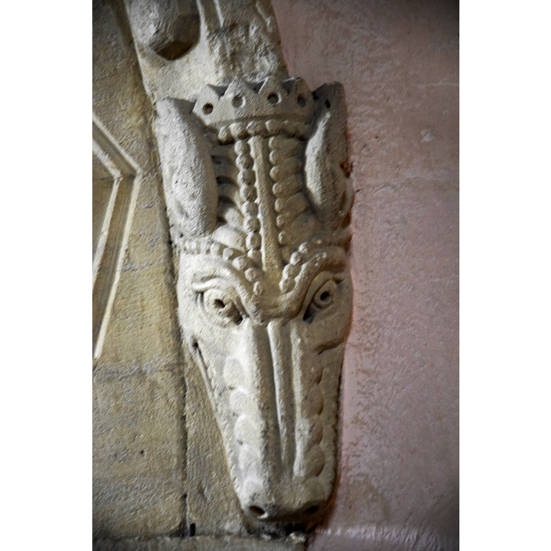 Source caption: "Pictured is the Dragonhead stop on one end of the Norman (1160) chancel arch."