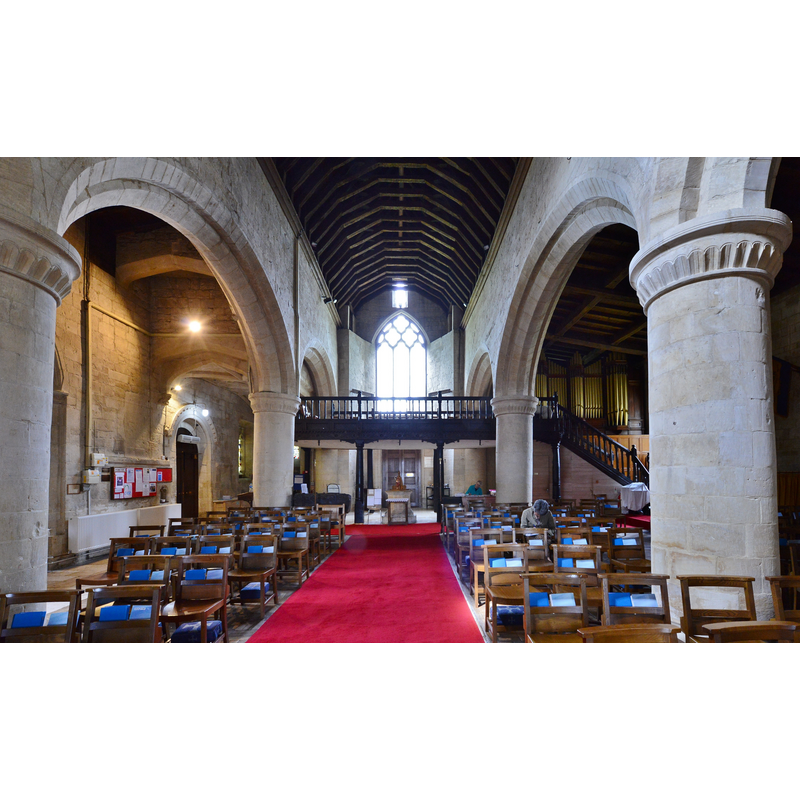 Source caption: "Bishops Cleeve, St. Michael and All Angels Church: Nave looking west with c17th Jacobean oak gallery". -- the stone font is visible at the far end, beneath the gallery