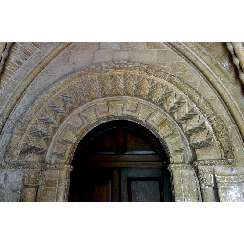 Source caption: "Bishops Cleeve, St. Michael and All Angels Church: Monster consuming another creature on the south doorway. A modestly presented Green Man can also be seen."