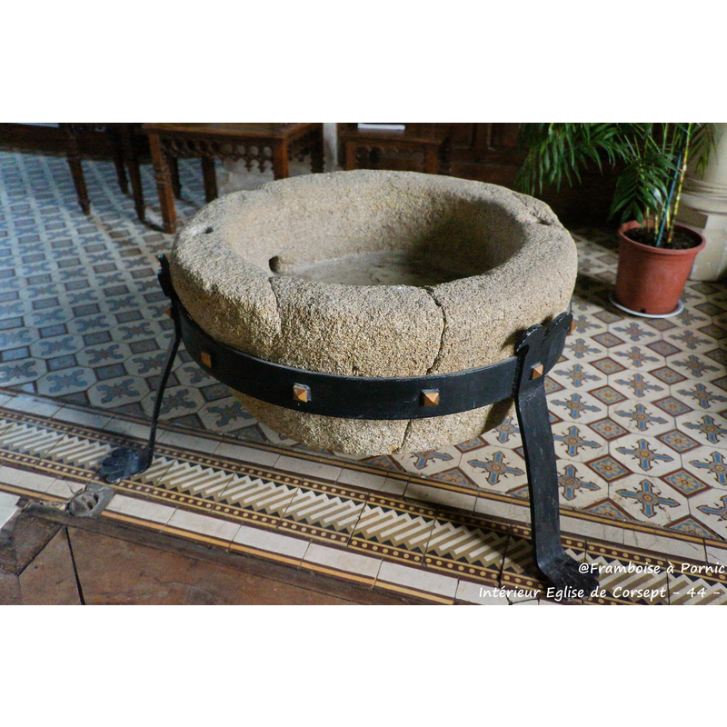 the stone basin suposedly of the 9thC mounted on a modern metal support frame