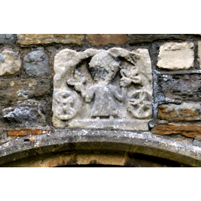 Source caption: "St Andrew, Churcham. The North door - a 19th century restoration. The sculpture above has experts puzzled as to date, but it could be as early as the 3rd century."