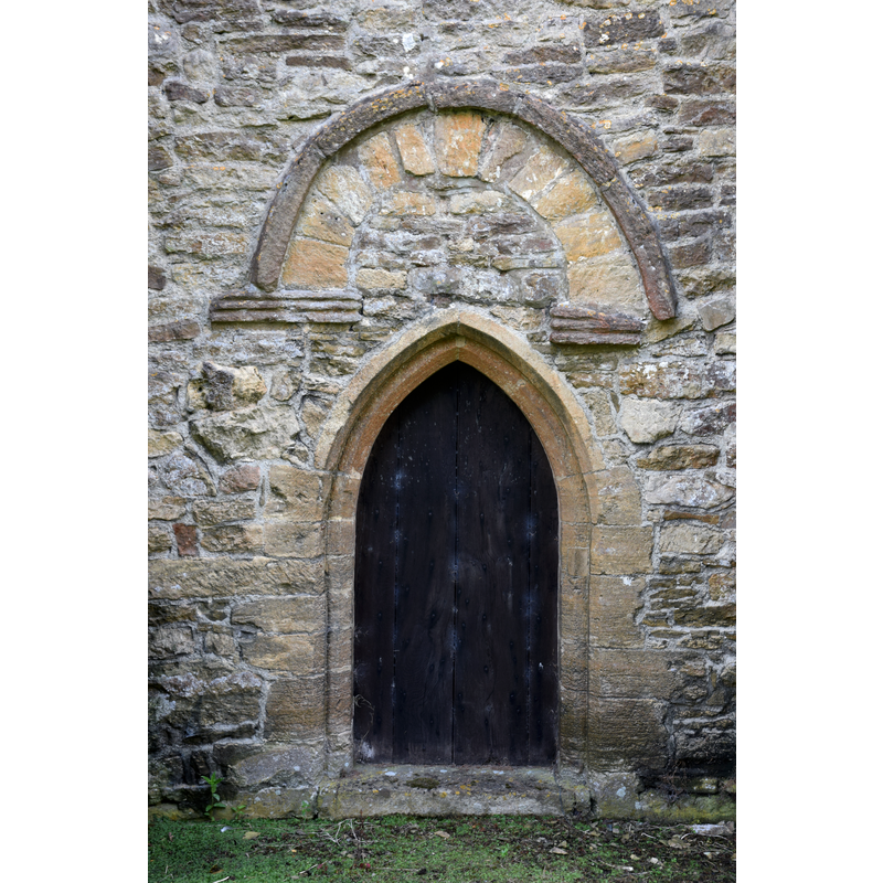 Source caption: "Miserden Church (St. Andrew), 7 September 2016. Pictured is the exterior of the early 11th Century Saxon north doorway, altered in the 14th Century with a new lowered doorway - nicknamed 'The Devil's Doorway'."