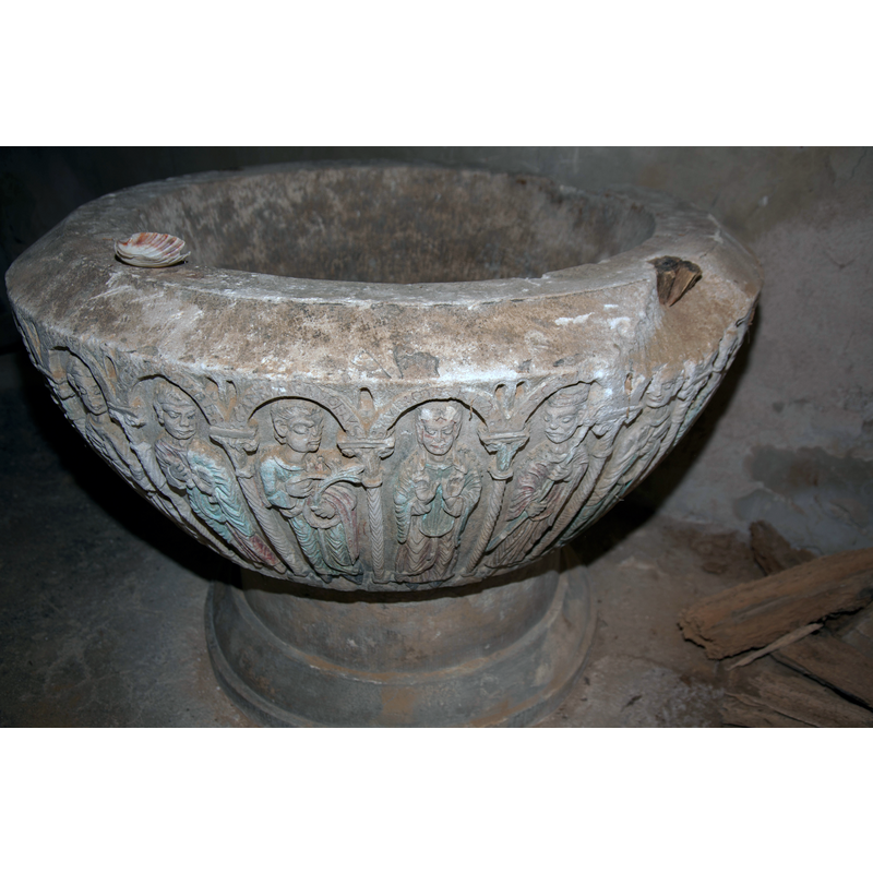 showing the Annunciation scene on the frint side -- notice the large damaged area on the upper rim of the basin, an anchoring spot for the hardware of an old cover, where the metal had split the stone; there is another plug, unbroken, at the opposite side of the rim (not visible here)