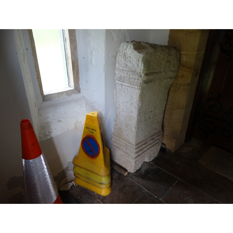 Source caption: "In the porch, and I love the way it takes up residence with a traffic cone, is a Roman altar. Apparently it comes from Featherwood, 3½ miles north of the fort at Rochester, and is dedicated to Victory and Peace."