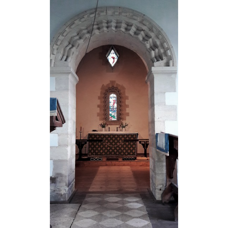 Source caption: "Into the chancel, St Osmund, Tarlton. A genuine Norman Romanesque chancel arch frames a neo-Norman east window and lozenge window above it in the east wall."