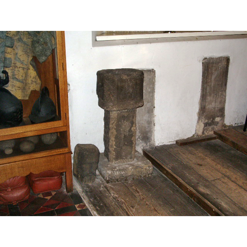Source caption: "St Mary's Parish Church, Penwortham, Font. This font which stands near to the Pulpit is inscribed "T. R. 1667" is believed to have been given by Thomas Robinson, Vicar from 1653 to 1654. This may not have originally been a Font at all but a plague stone for disinfecting money or a vessel for the Clergy to wash their hands following Communion".